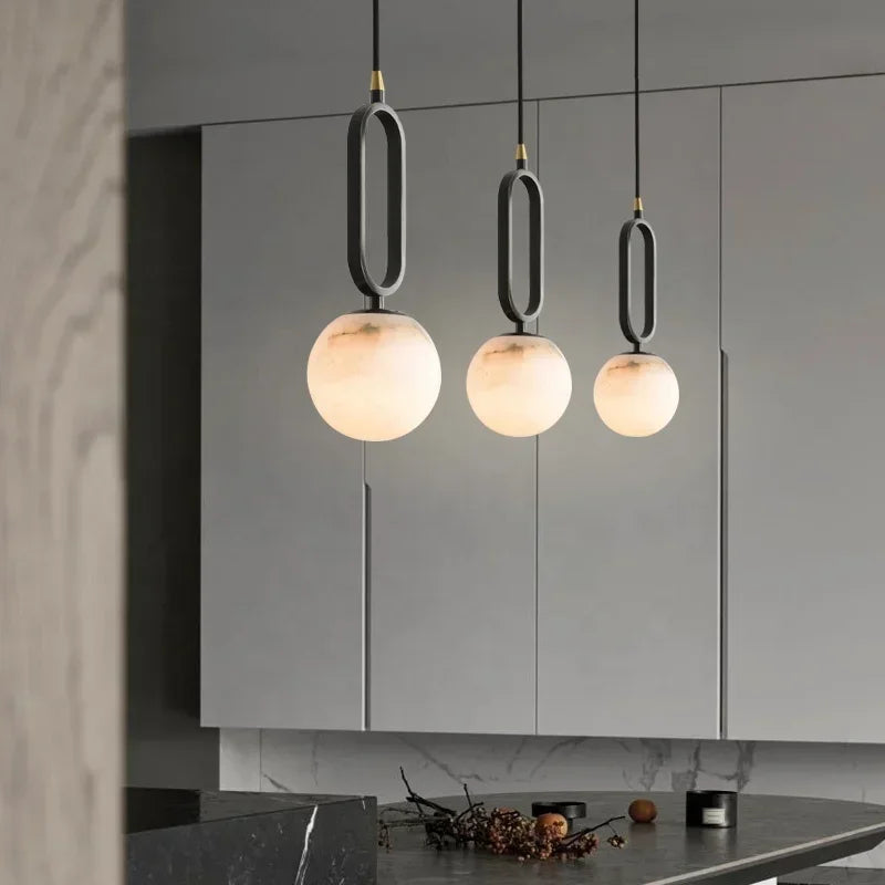 Orbit Glow Marble Brass Pendant with 12 cm marble sphere black ring frame and gold plated brass accents